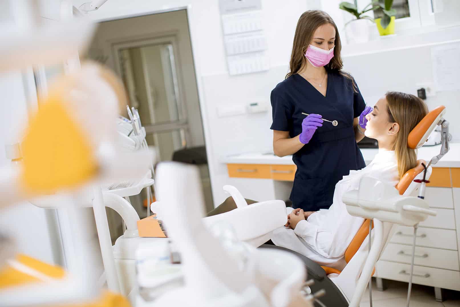 Young woman at oral checkup at the dentist office